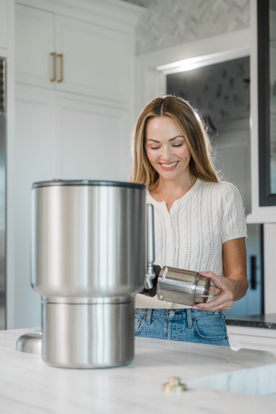 Woman with the Rorra Countertop system in a bright kitchen