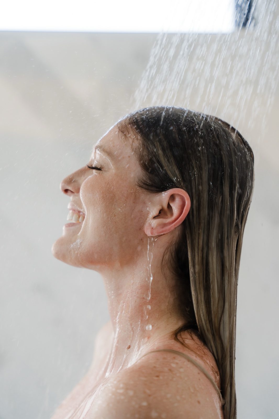Woman relaxing in a bath with soft daylight